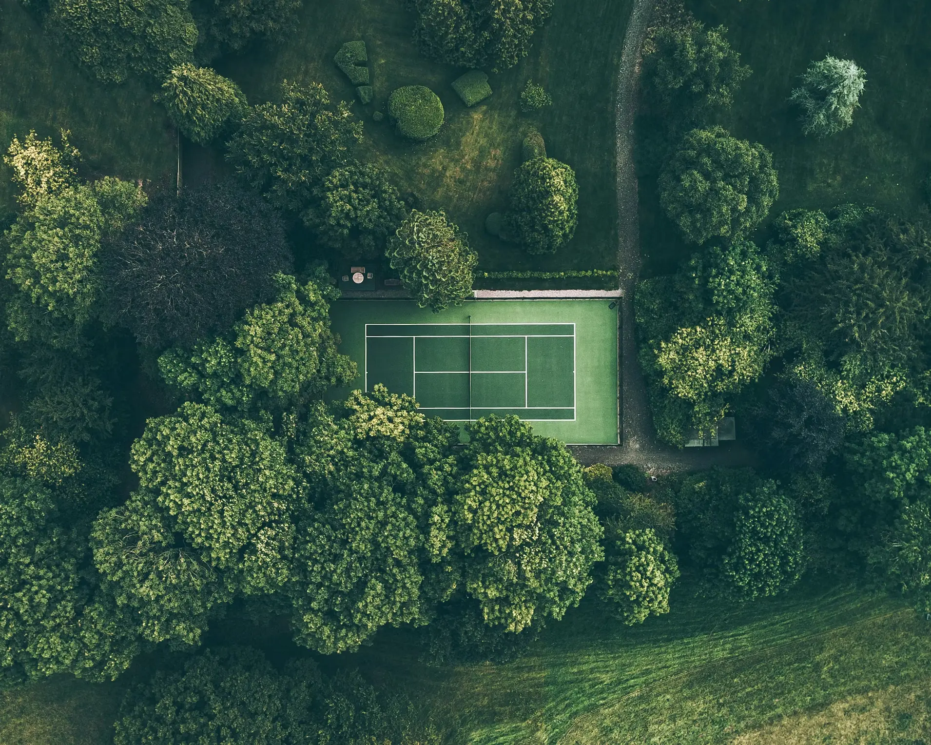 Tennis players on a club court during a doubles session